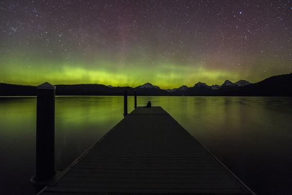 Aurora displayed over dock and water in Glacier National Park.