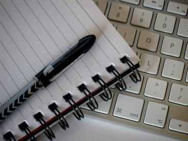 Pen on a notebook on a keyboard 