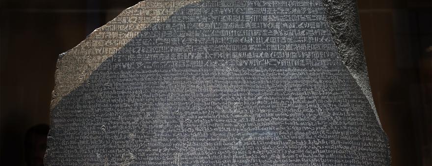 Large grey statute depicting Rosetta Stone.