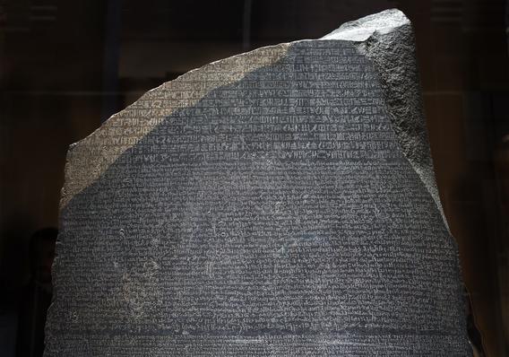 Large grey statute depicting Rosetta Stone.