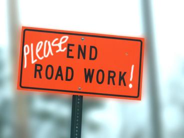 Orange End Road Work sign with the word please written in.