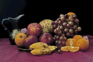 Varieties of fruit and a pitcher on a table.